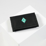 black purse on a white pedestal