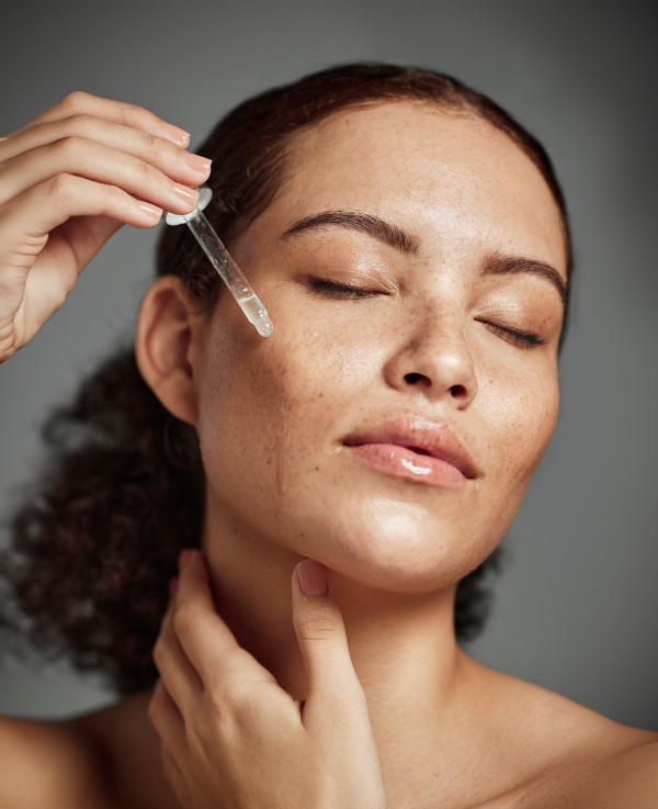 Lady applying a serum to her face