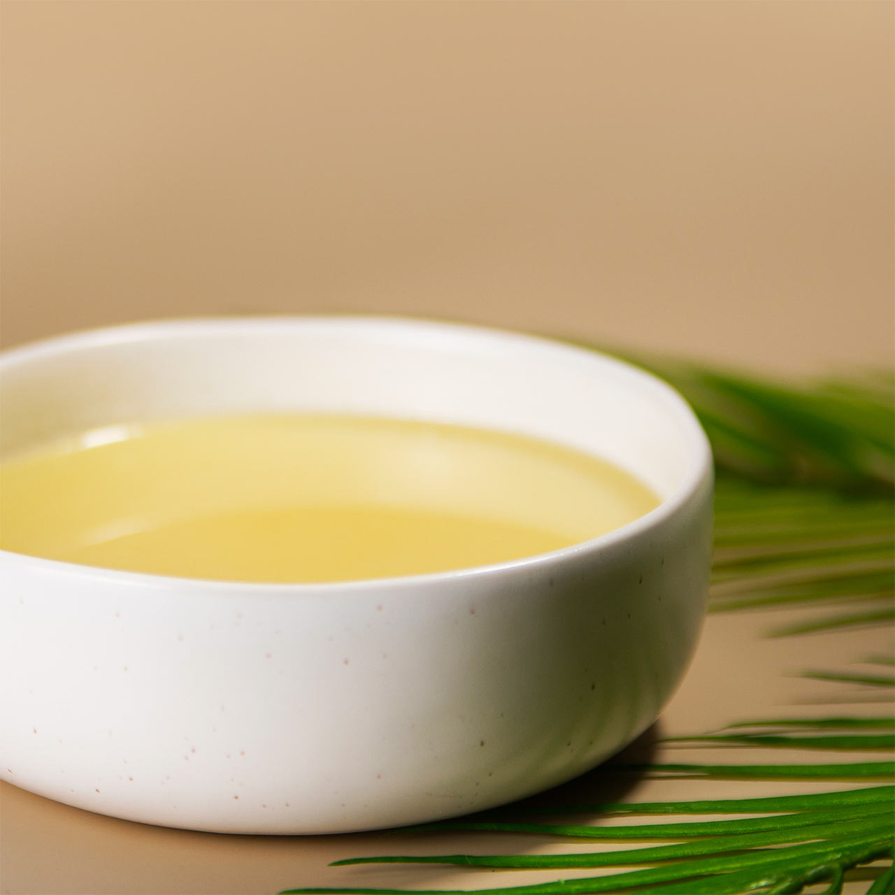 White bowl filled with a carrier oil from New Directions Aromatics