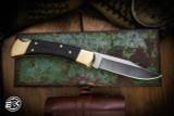 Buck Knives 110 Manual Folding Knife Ebony Brass Bolsters 3.75" 420HC Clip Point Satin 110BRS-B
