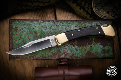 Buck Knives 110 Manual Folding Knife Ebony Brass Bolsters 3.75" 420HC Clip Point Satin 110BRS-B