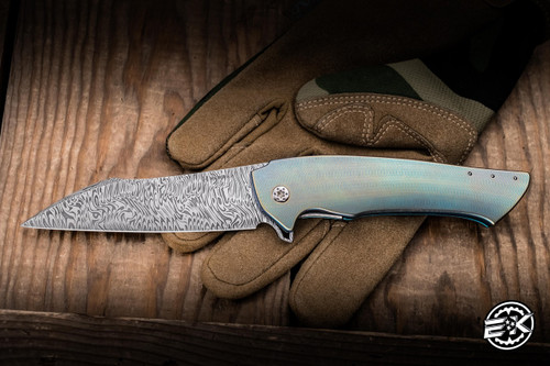 Herman Knives Ovium II Folder Knife Blue/Yellow Titanium/Black Timascus Accents 4.06" Damasteel Mirror Polish 0197