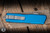 Preowned-Microtech Scarab II Executive OTF Automatic Knife Blue Aluminum 4" M390 Drop Point Apocalyptic Serrated 1176-11APBL