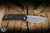 ProTech Mordax Manual Flipper Knife Black Aluminum/Casted White Brass "USA 250th", White Pearl Button 3.75" MagnaCut Stonewash - Blade Show Exclusive