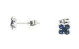 Close-up side and front views of matching royal blue sapphire floral cluster stud earrings in polished white gold, showing the gemstone settings, posts, and butterfly backs.