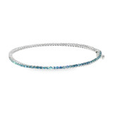 Side view of prong-set fancy vivid blue round lab grown diamonds in a 14K white gold tennis bracelet