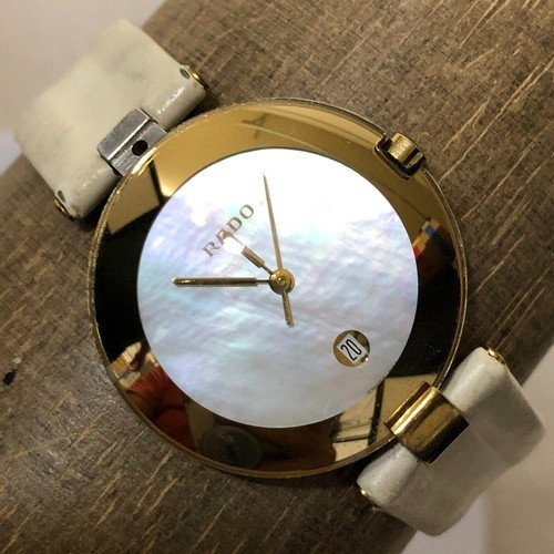 Rado Coupole watch 129.4077.4N featuring a black dial with gold-tone hands and markers, 30 mm stainless steel case, Swiss quartz movement, date display at 6 o’clock, and black leather strap.