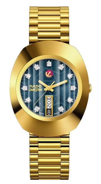 Front view of the Rado The Original Automatic R12413523 featuring a 35 mm sculpted gold-tone case, vertically textured blue dial with sparkling crystal-style hour markers, gold-tone hands, Rado DiaStar branding, day-date display at 6 o’clock, and matching gold-tone bracelet.