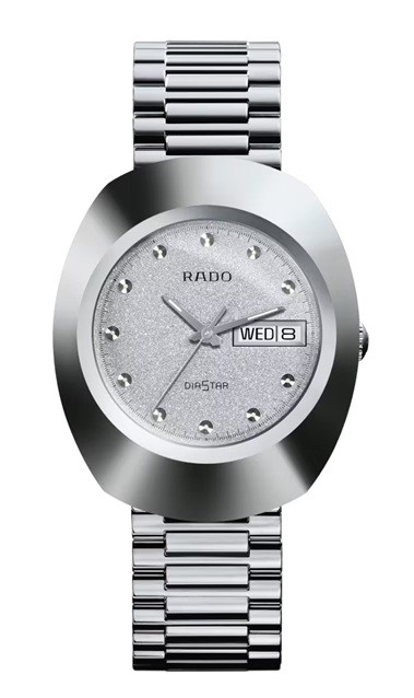 Front view of the Rado The Original R12391103 featuring a 35.1 mm sculpted silver-tone case, shimmering textured silver dial with faceted hour markers, silver-tone hands, Rado DiaStar branding, day-date display at 3 o’clock, and a polished silver-tone bracelet.
