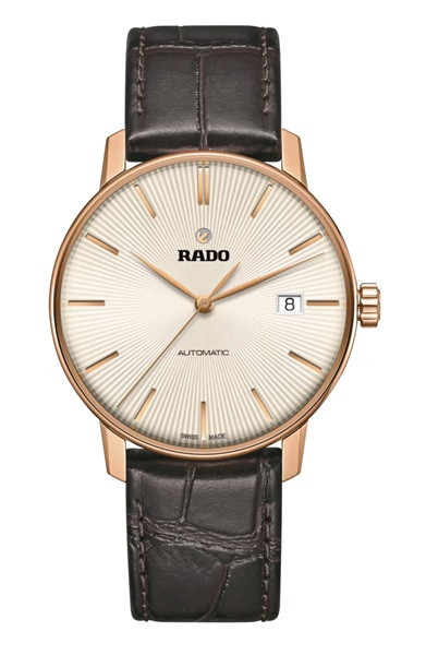 Front view of the Rado Coupole Automatic R22861115 featuring a 37.7 mm rose gold-tone case, textured silver sunray-style dial, slim rose gold-tone hands and hour markers, date display at 3 o’clock, Rado branding, and a dark brown crocodile-pattern leather strap.