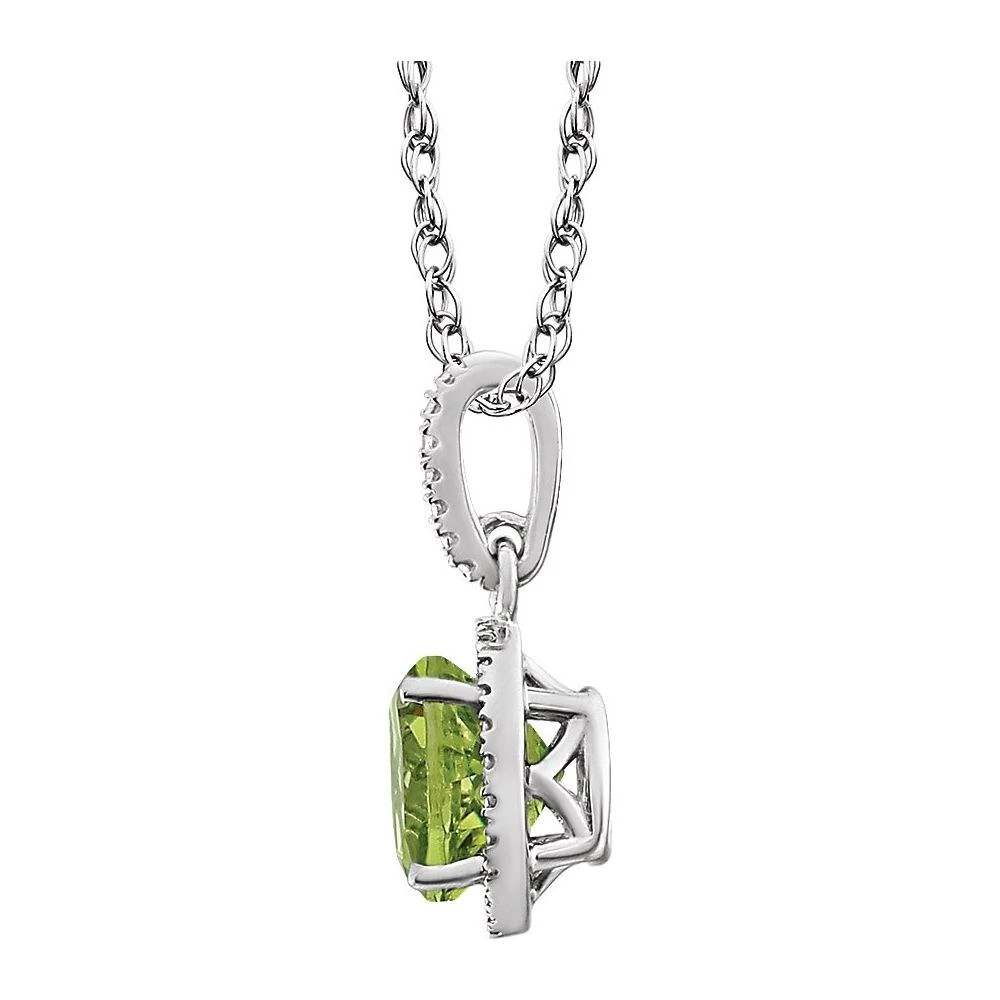 Side profile of a peridot diamond halo pendant showing the white gold gallery and setting