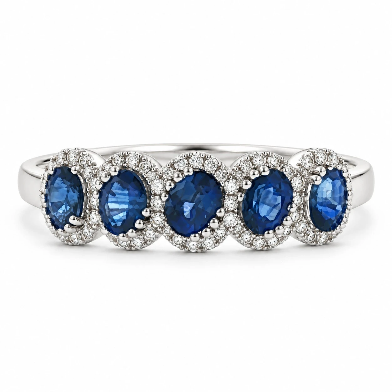 Five-stone royal blue sapphire ring with individual diamond halos in 18K white gold
