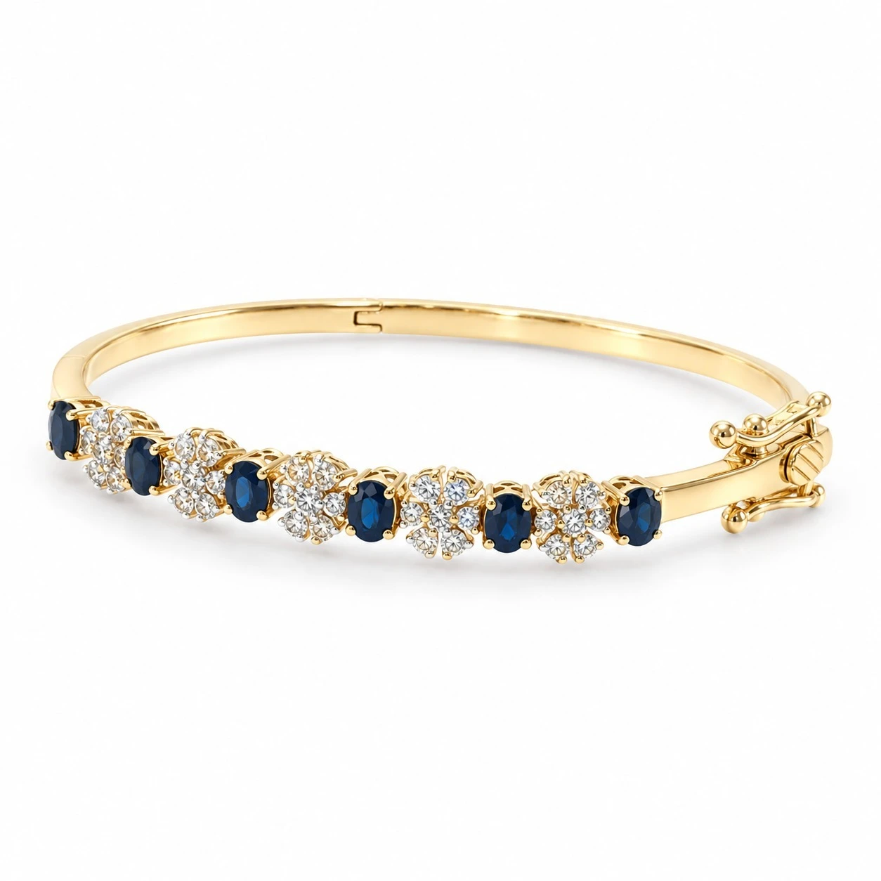 Alternating blue sapphire and diamond floral cluster bangle in 18K yellow gold, three-quarter view