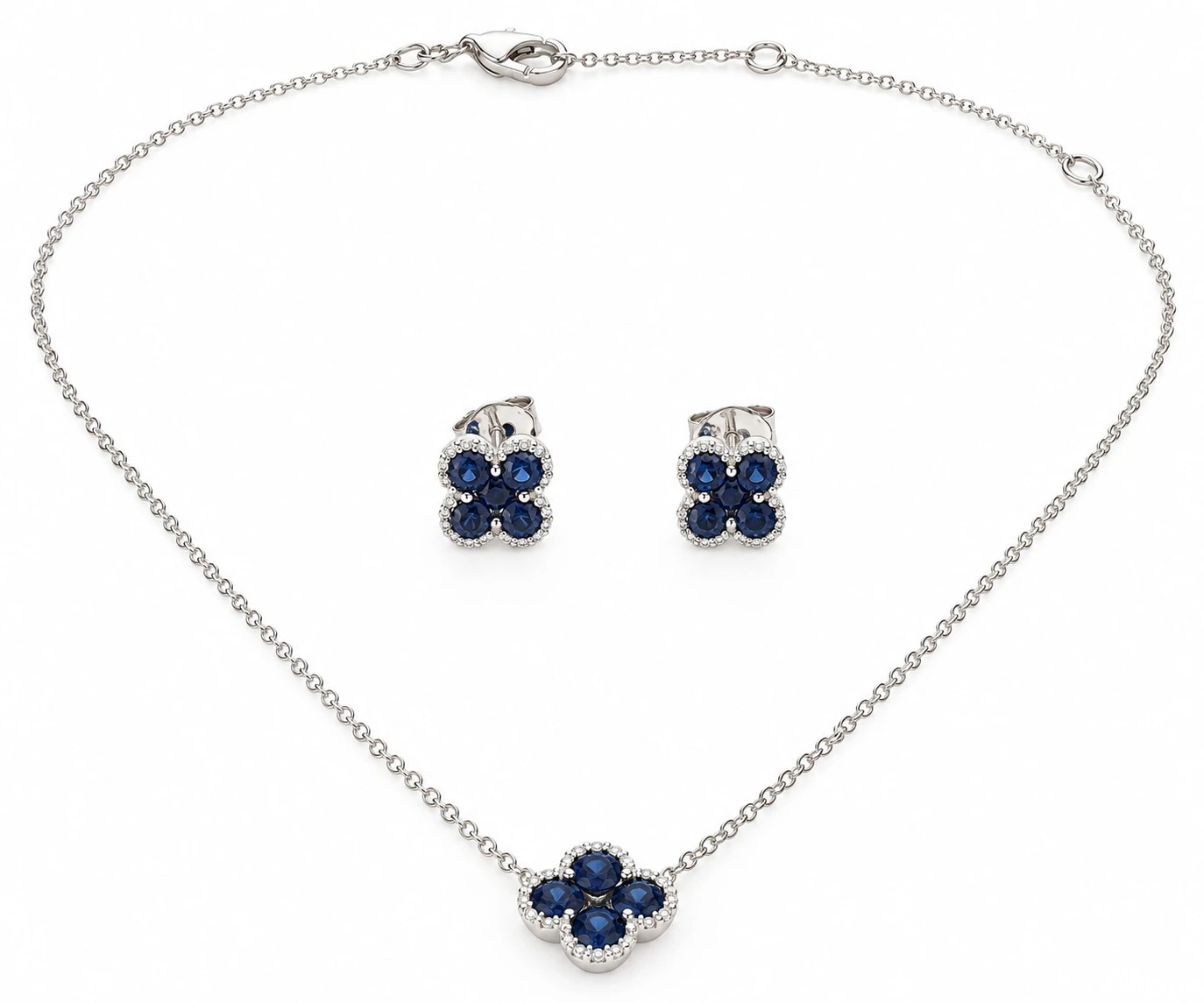 Royal blue sapphire floral cluster necklace with matching stud earrings in 18K white gold on a fine cable chain