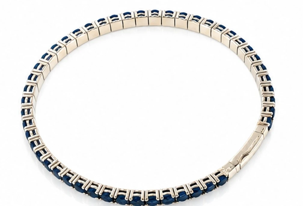 Reverse of a blue sapphire line bracelet in 14K white gold showing the box clasp and figure-eight safety catch