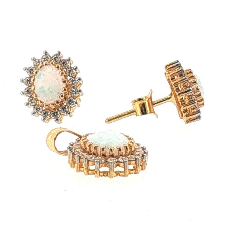 Oval opal halo pendant necklace and matching studs in 22K yellow gold with a sunburst halo of white accent stones