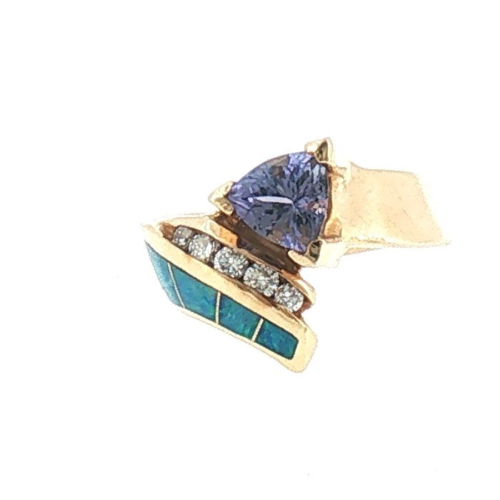 Asymmetrical 14K yellow gold cocktail ring with a trillion-cut tanzanite, a curved row of diamonds and opal inlay