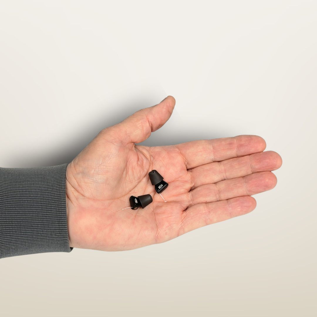 Audicus Mini Hearing Aids in Hand