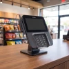 VeriFone M400 on retail counter with stylus pen holder attached