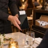 Server printing a receipt on a Verifone T650p at a restaurant table