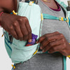 Close up of woman wearing Ultimate Direction Ultra Vesta, pulling energy gel from pocket