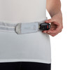 Woman inserting key into waist belt pocket of Ultimate Direction Race Belt 5.0