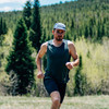 Man running on trail wearing  Ultimate Direction Men's Cumulus Tank