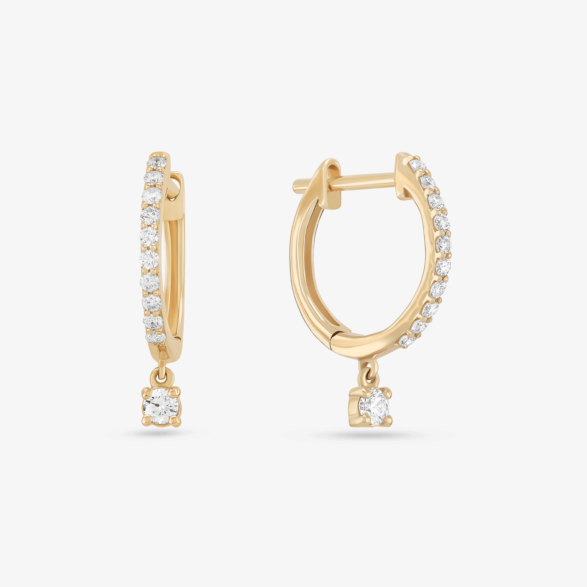 14K yellow gold pave huggies with solo dangle diamonds
