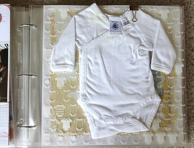 Scrapbook baby's first onesie to remember just how small they were when you first brought them home (via Allie Edwards)
