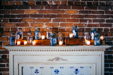 Mason Jar display of family wedding portraits on a mantle | photo by Tiffani Jones