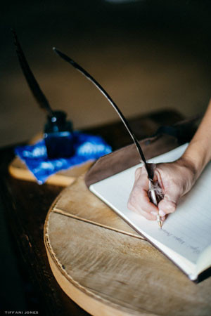 Feather pens give your guest book signing table a vintage flair | photo by Tiffani Jones