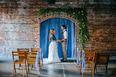 Chambray Industrial Wedding Ceremony with a brick backdrop | photo by Tiffani Jones