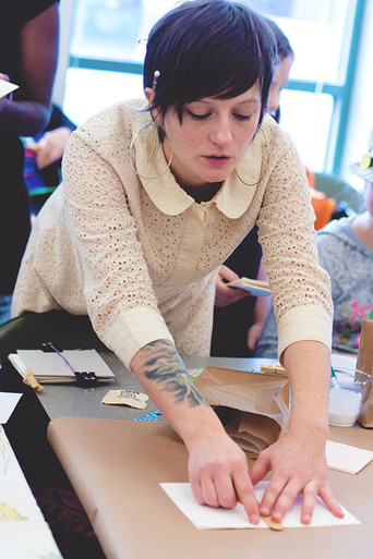 Amy demonstrating bookbinding at the East Atlanta Library