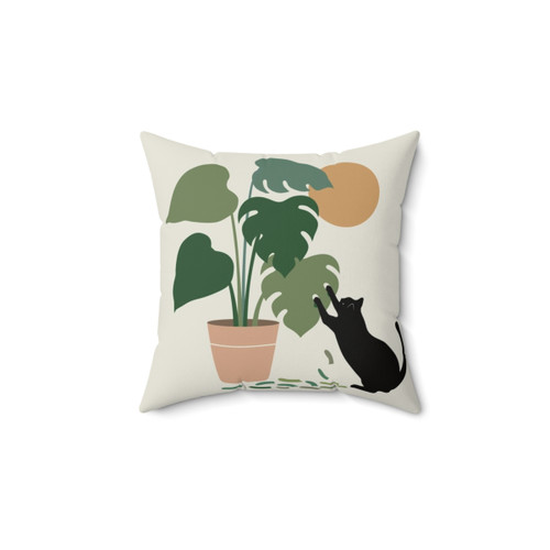 Monstera leaf pillow with playful black cat