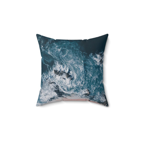 Aerial beach photography throw pillow featuring ocean and pink sand