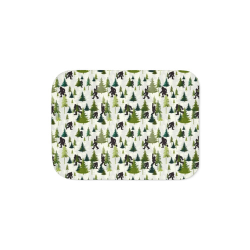 Sherpa blanket featuring a Bigfoot design in a forested outdoor scene