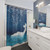 Teal blue watercolor shower curtain featuring whales and other sea creatures