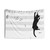 Mischievous cat playing with sheet music on tapestry