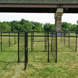 Front shot of a dog park made from fencing, with a swinging door and latch.