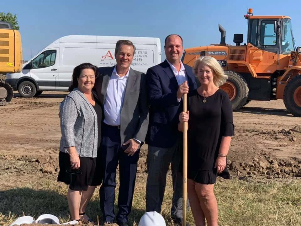 Family members with ceremonial shovels at the Accent Lighting groundbreaking in 2019
