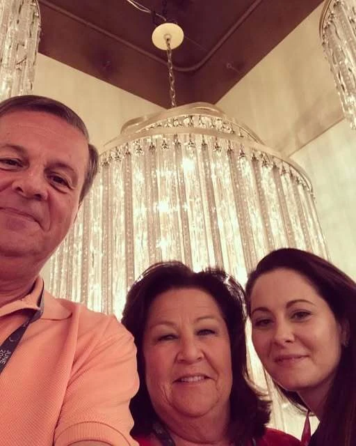 Accent Lighting colleagues with a chandelier in the showroom