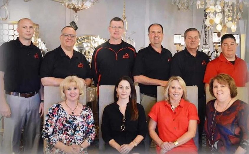 An earlier Accent Lighting team photographed in the showroom