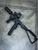 Custom TX22 chassis with folding brace, suppressor, and red dot optic mounted, shown on concrete floor. Lightweight polymer chassis designed for enhanced stability, optic mounting, and modular accessories for the Taurus TX22 platform.