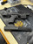 Custom TX22 pistol chassis shown on workbench with ammunition and extended magazine removed, highlighting modular polymer chassis design, improved ergonomics, optic-ready mounting surface, and compatibility with TX22 extended magazines.