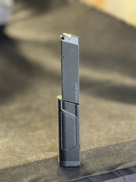Side profile of TX22 extended magazine standing upright, displaying increased capacity length, reinforced feed lips, and ergonomic magazine extension for smoother reloads.