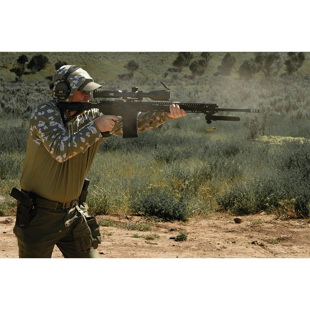 Shooter firing long-range rifle