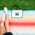 Polar Sunset Logo On Ground Lifestyle View - Polar Sunset Outdoor Blanket