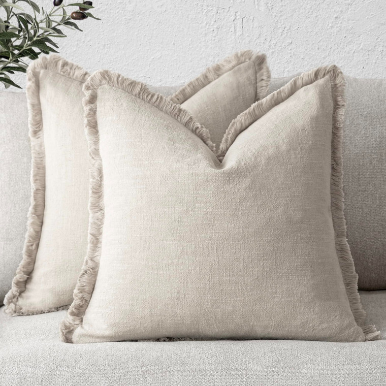 Set of 2 beige linen fringe tassel throw pillow covers 20x20 inches with boho farmhouse style on a sofa