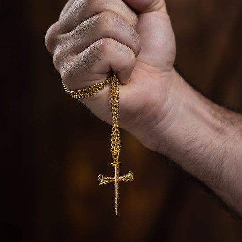 Shields of Strength Stainless Steel Gold Plated Nail Cross Necklace-John 19:30  Man's hand holding the necklace