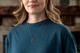 Shields Of Strength Women's Faith, Hope, Love Cross Necklace - 1 Corinthians 13:13. Woman wearing necklace